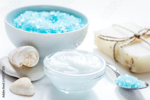 blue sea salt, soap and body cream on white desk background