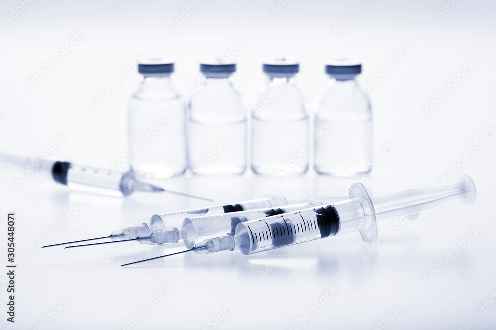 Glass medicine vials and Syringe on white background Glass medicine vials and Syringe on white background