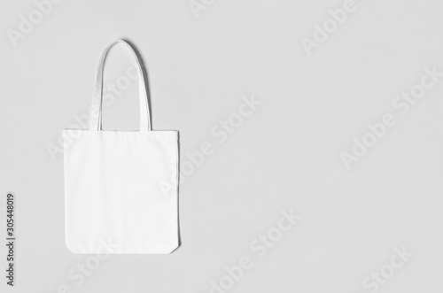 White tote bag mockup on a grey background with copyspace.