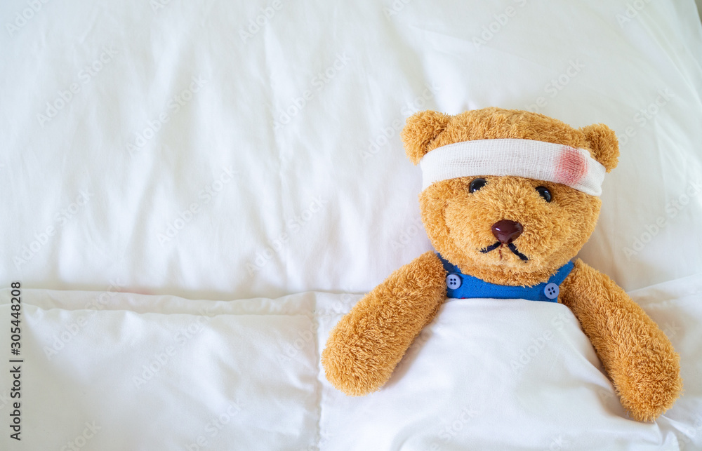 The teddy bear was sick in bed after being injured in an accident. Getting life insurance and accident insurance concept