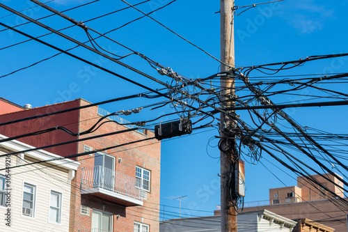 Telephone Lines and Pole in front of Residential Buildings and Homes in Astoria Queens New York photo
