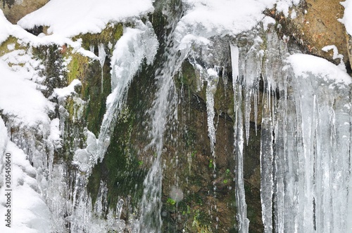Beautiful mountain waterfall covered in ice