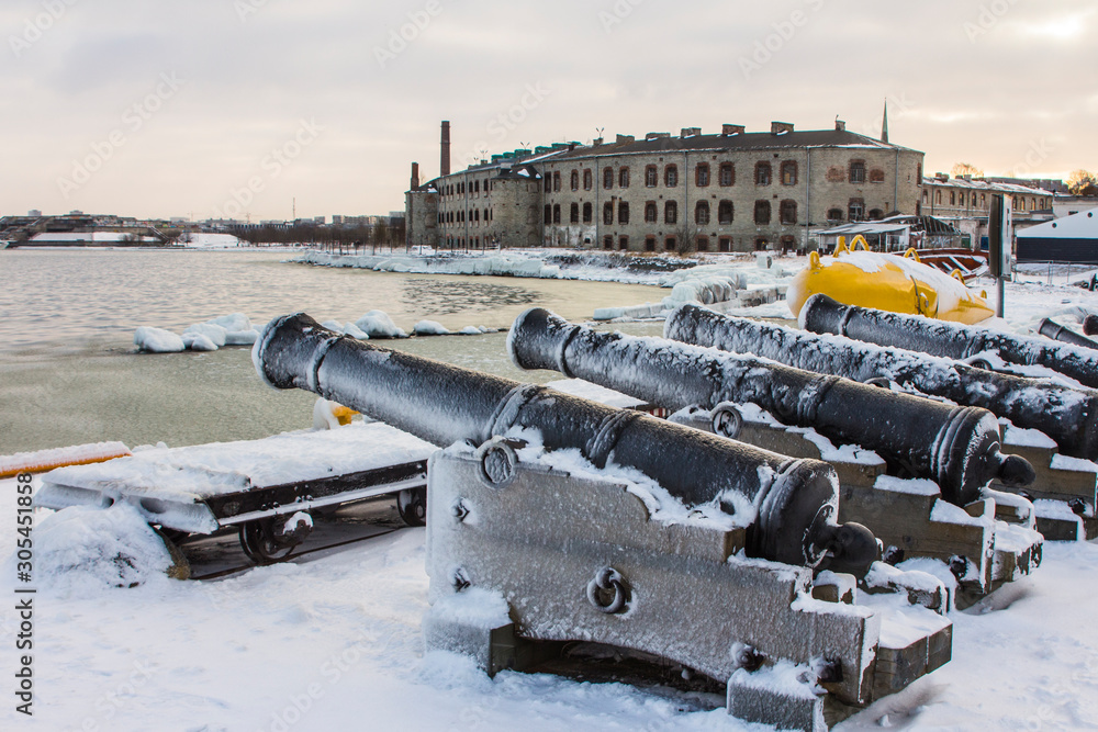 Historic guns on the pier at the Flight Harbor Museum in Tallinn in winter. Estonia Historic guns on the pier at the Flight Harbor Museum in Tallinn in winter. Estonia