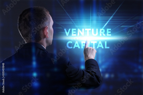 Business, Technology, Internet and network concept. Young businessman working on a virtual screen of the future and sees the inscription: Venture capital