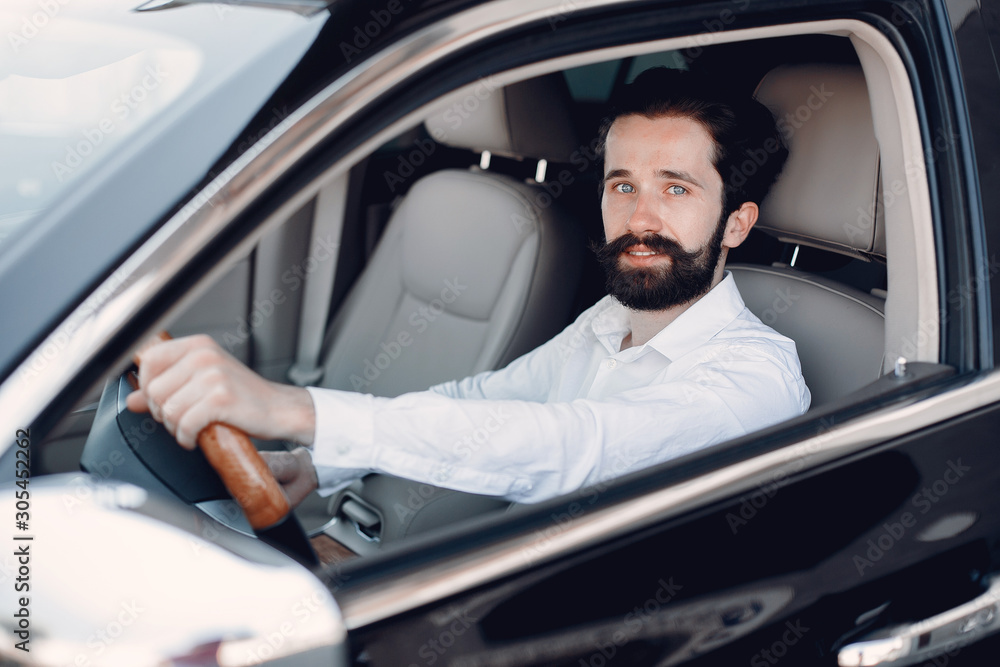 Man buying the car. Businessman in a car salon Man buying the car. Businessman in a car salon