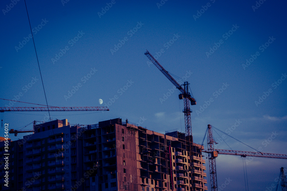 House under construction against the sky and moon House under construction against the sky and moon