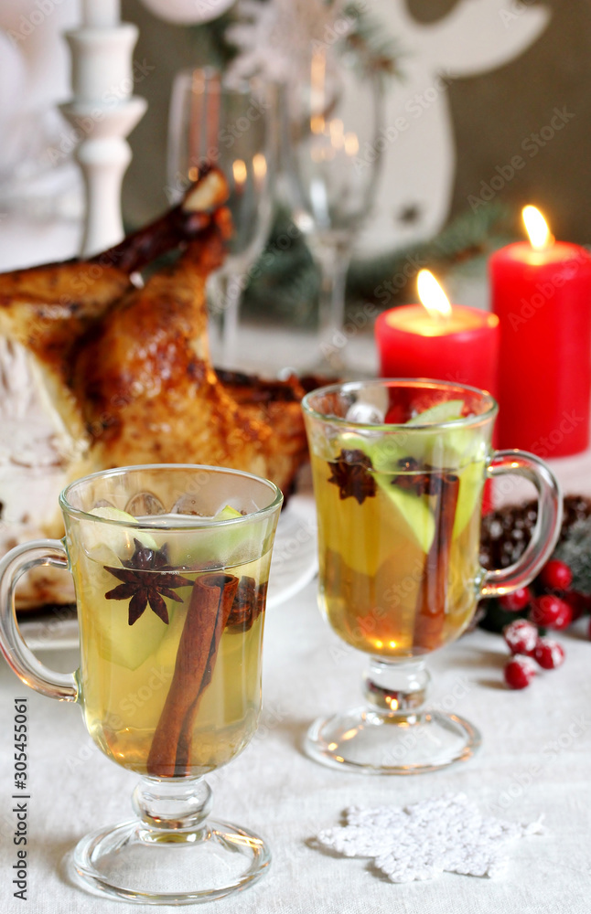 christmas hot cider. hot winter drink Cranberry Apple Cider Punch. Garnish with apples, oranges, and cranberries. hot apple cider with spices on a festive table on Christmas or New Year.