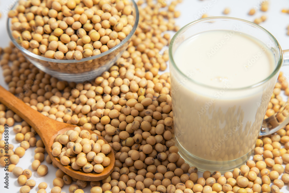 Soy milk pouring in glass and soy bean or soya bean . Alternative Soy milk healthy concept. Soy milk pouring in glass and soy bean or soya bean . Alternative Soy milk healthy concept.
