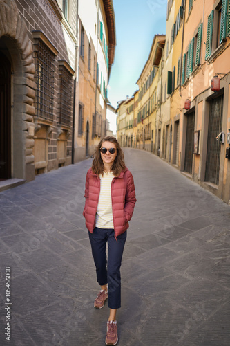 Happy young woman in typical Italian empty street. © takoburito