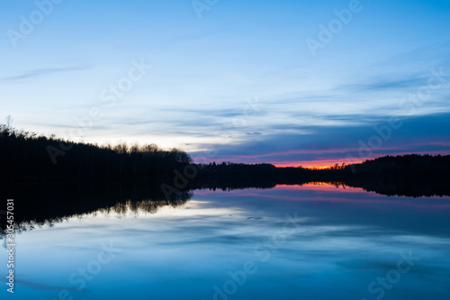 Fototapeta Naklejka Na Ścianę i Meble -  Evening with colorful sunset at the lake