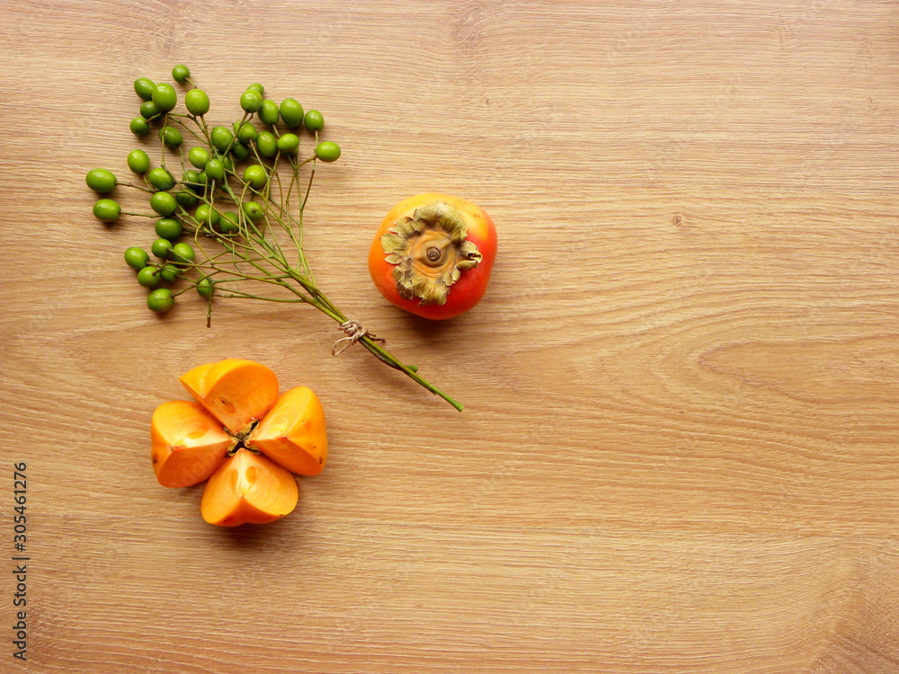 autumn still life with persimmon on a wooden background autumn still life with persimmon on a wooden background