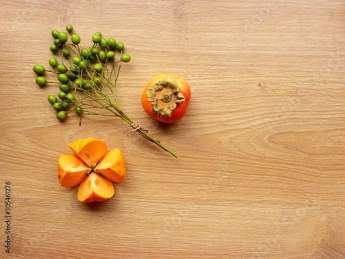 autumn still life with persimmon on a wooden background