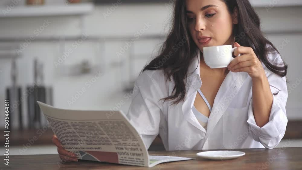 woman reading newspaper and drinking coffee woman reading newspaper and drinking coffee