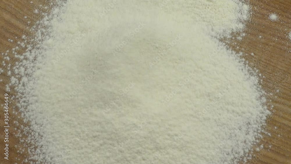 Sifting of flour on a board. Sifting of flour on a board.