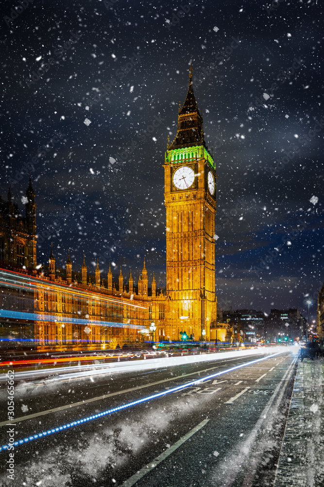 Der beleuchtete Big Ben Turm und Westminster Palast in London im Winter mit Schneefall