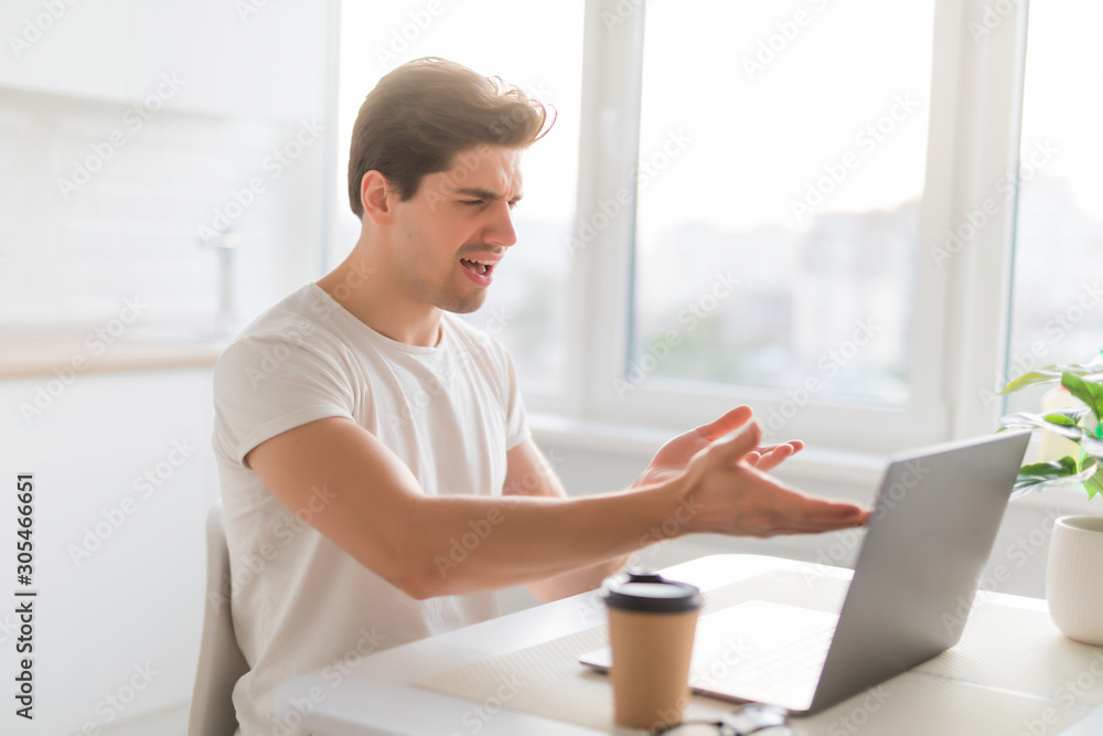 Entrepreneur angry and furious man with a laptop at home Entrepreneur angry and furious man with a laptop at home