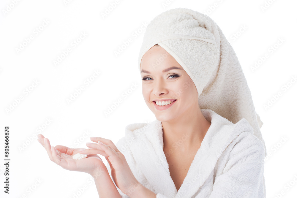 Portrait of a young beautiful woman in a Terry robe and with a towel on her head. Beauty and skin care Portrait of a young beautiful woman in a Terry robe and with a towel on her head. Beauty and skin care