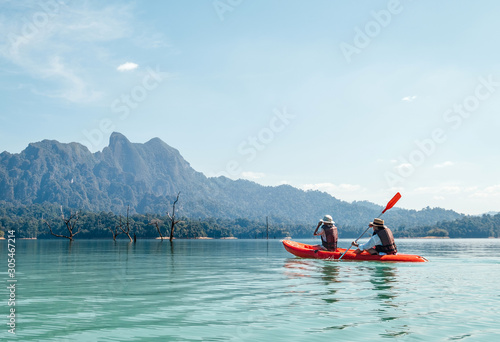 Mother and son floating on kayak together on Cheow Lan lake in Thailand  © Soloviova Liudmyla