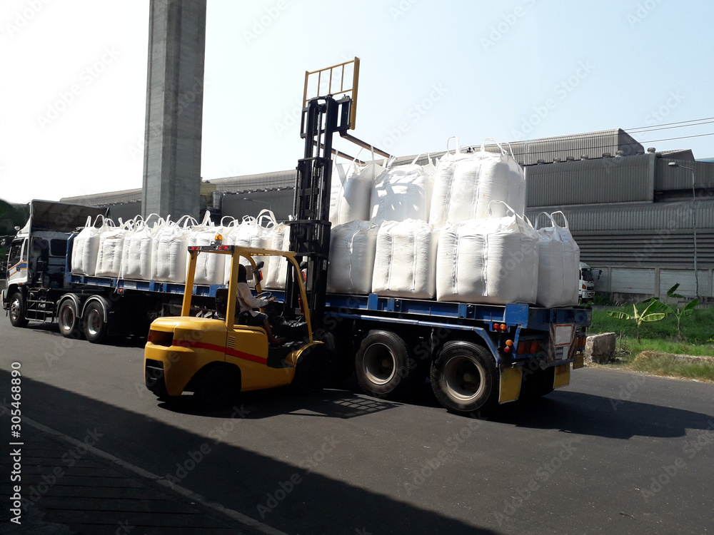 Trailer loading goods fertilizer urea sack jumbo to customers. 