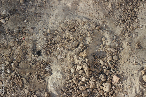 Construction site detail with sand, cement, ground and stones, rubble top down