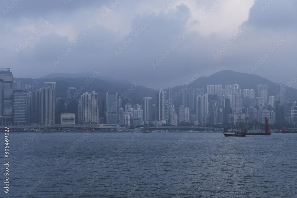 Fototapeta premium Hong Kong city landscape day and evening with lights. Skyscrapers overlooking the mountains and the sea day and evening. Night lights. China