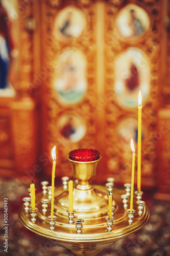 The candle flame in orthodox church, selective focus, closeup