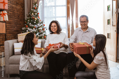 asian family gift exchange tradition on christmas day at home