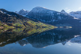 snowcapped mountains in blue sky  reflected in lake Waeggitalersee