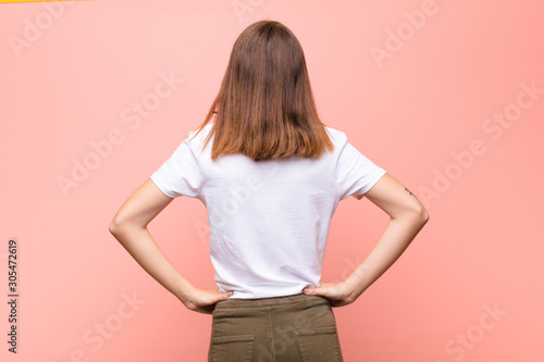 Фотография young red head woman feeling confused or full or doubts and questions, wondering