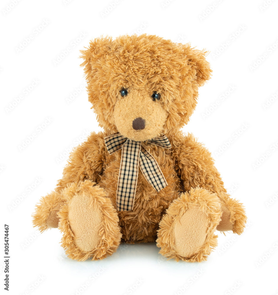 Bear plushie doll isolated on white background with shadow reflection. Plush stuffed puppet on white backdrop. Light brown fluffy toy for children. Cute furry animal plaything.
