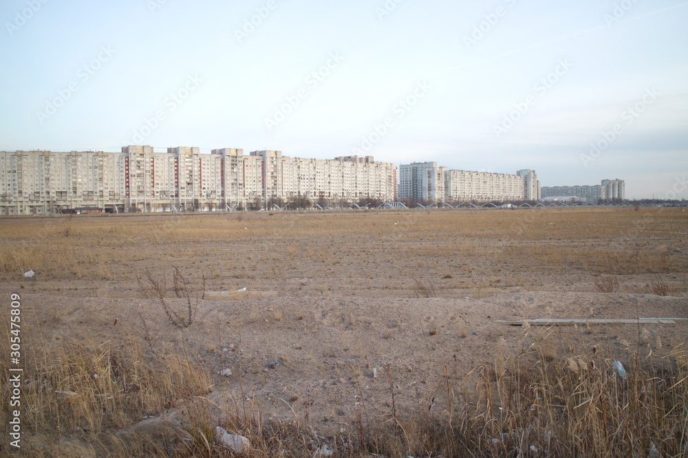 Wasteland at the construction site of a residential quarter on the outskirts of the city in the autumn evening Wasteland at the construction site of a residential quarter on the outskirts of the city in the autumn evening