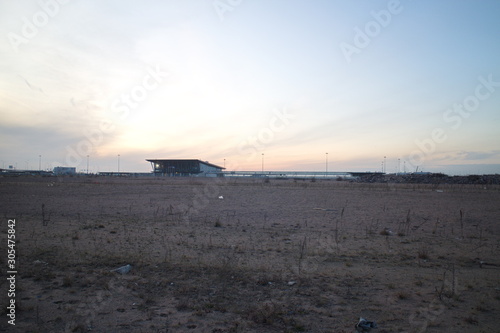 Wasteland at the construction site of a residential quarter on the outskirts of the city in the autumn evening