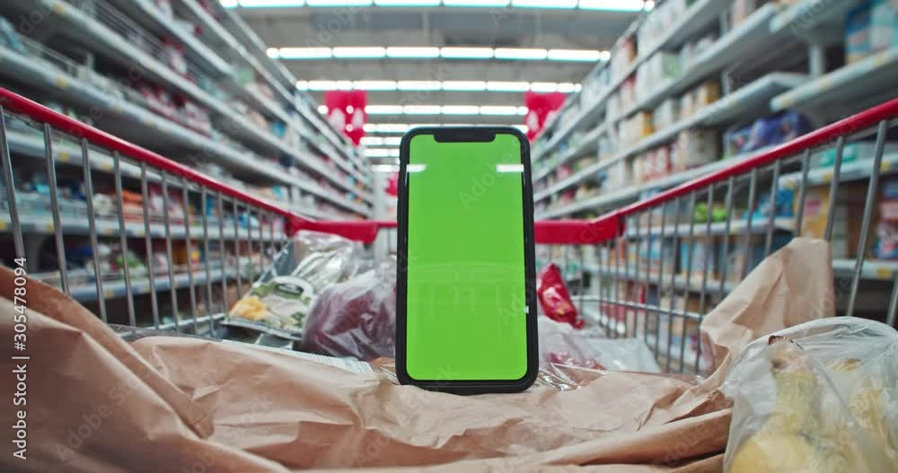 Smartphone vertical mockup with greenscreen in supermarket trolley
