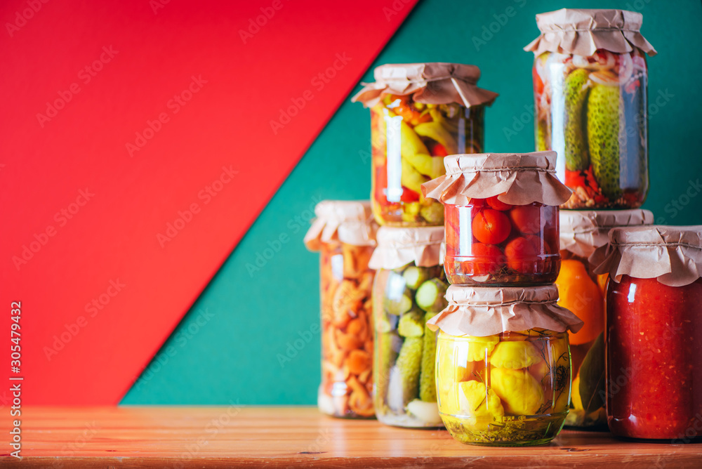 Preserved and fermented food in glass jars. Fermented food. Autumn canning. Сucumber, squash and tomatoes pickling and canning into glass jars.