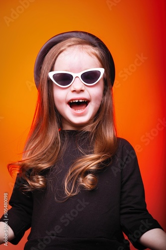 Happy girl in sunglasses. Funny young child waiting on style, fashion concept for child. holiday, sale concept with place for text