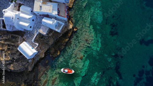 Aerial drone photo of traditional wooden fishing boat in old port of Mykonos island,  Cyclades, Greece © aerial-drone
