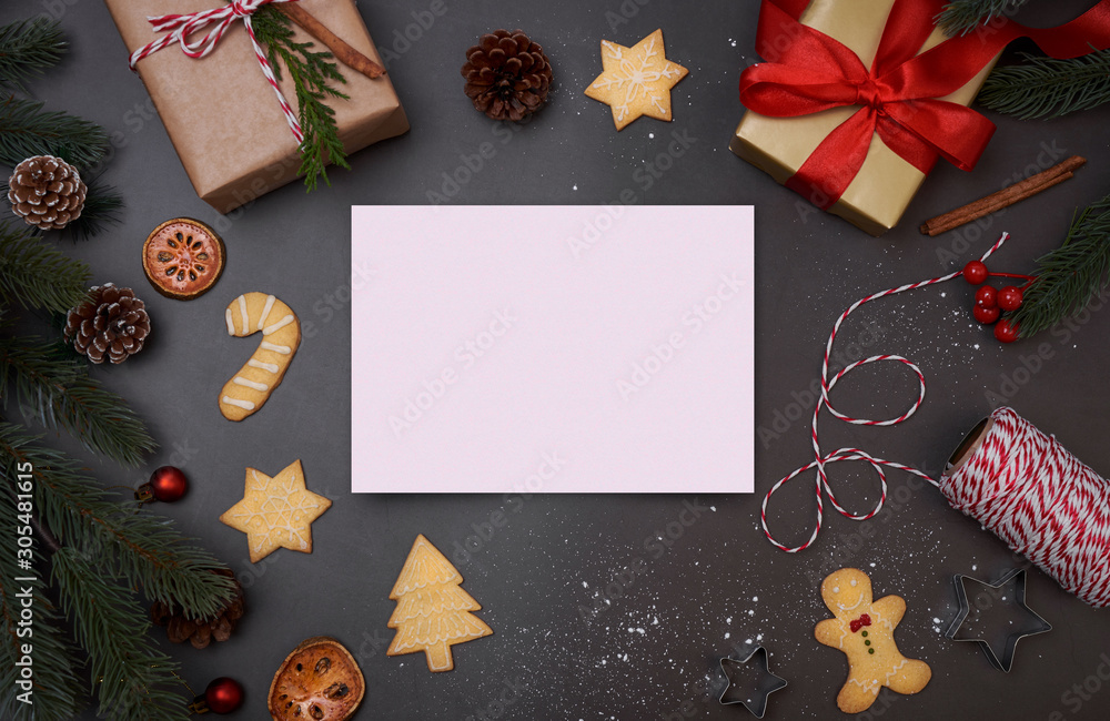 Christmas postcard with decorations gift box and christmas cookie on black background. winter, new year concept. Flat lay, top view, copy space. Christmas postcard with decorations gift box and christmas cookie on black background. winter, new year concept. Flat lay, top view, copy space.