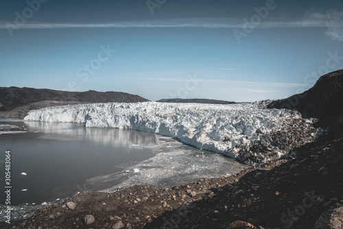 Wallpaper Mural Greenland, Eqip Sermia, Eqi Glacier in Greenland Disko Bay. Boat trip in the morning over the arctic sea,Baffin Bay, calving glacier. Ice breaking of on a blue sky wth clouds. Torontodigital.ca