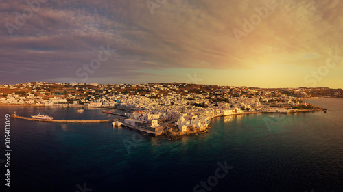 Fototapeta Naklejka Na Ścianę i Meble -  Aerial drone panoramic photo of picturesque old port in main village of Mykonos island at sunrise with beautiful colours, Cyclades, Greece
