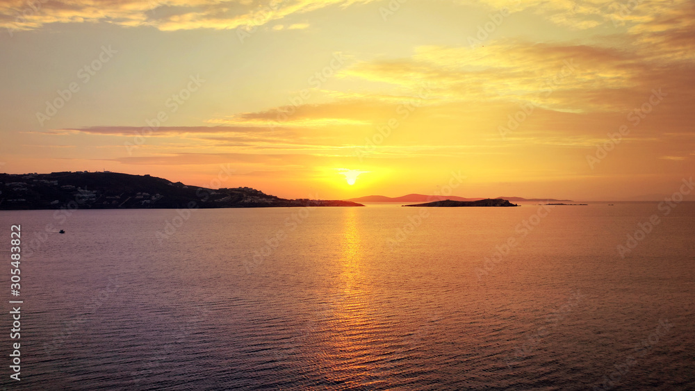 Aerial drone photo of beautiful sunset as seen from main village of Mykonos island, Cyclades, Greece