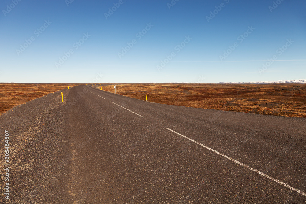 Road on a calm deserted spring landscape of Iceland
