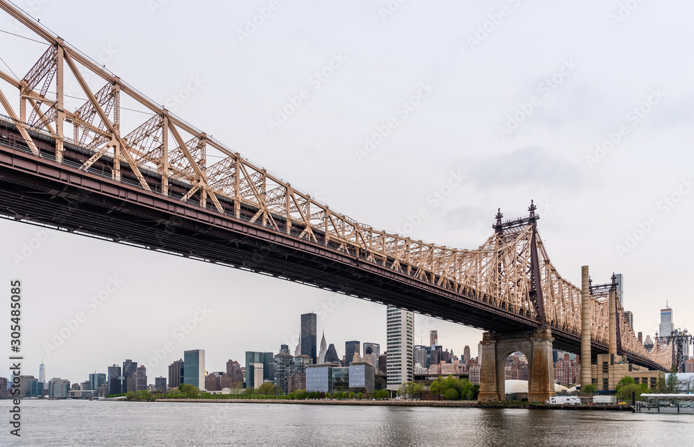 New York city Queensboro bridge over East river. View on Roosevelt Island from Queens park 