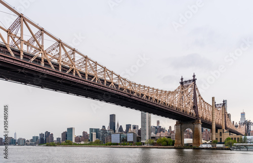 New York city Queensboro bridge over East river. View on Roosevelt Island from Queens park 