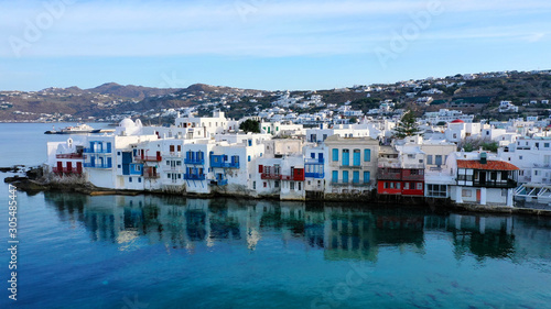 Aerial panoramic view of world famous whitewashed little Venice picturesque settlement in main village of Mykonos island with beautiful deep blue sky and clouds, Cyclades, Greece