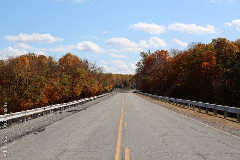 A long empty highway in the countryside on a sunny day.