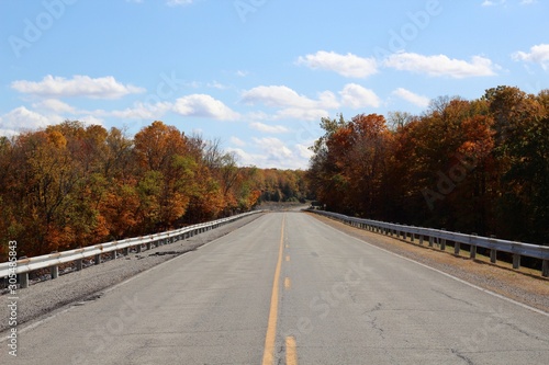 A long empty highway in the countryside on a sunny day.