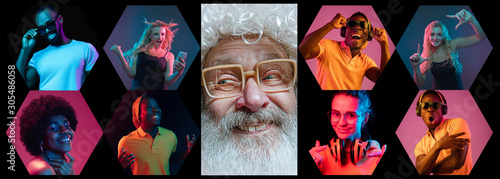 Emotional Santa Claus and his entourage greeting with New Year 2020 and Christmas. Man in traditional costume with multiethnic group of his friends in neon lights. Concept of holidays, winter mood.