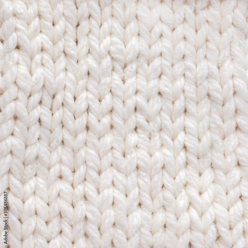 White knitted texture background. Warm winter clothes.