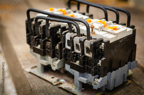 Electromagnetic motor protection device. Close-up of used electromagnetic starter. Electric starter for scheduled maintenance. Selective focus.