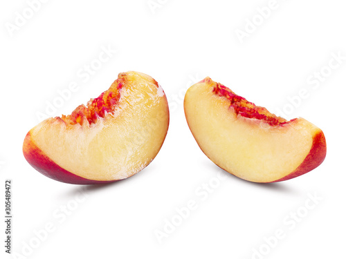 Two unpitted, smooth-skinned nectarine fruit slices isolated on white background with copy space for text or images. Close-up shot.